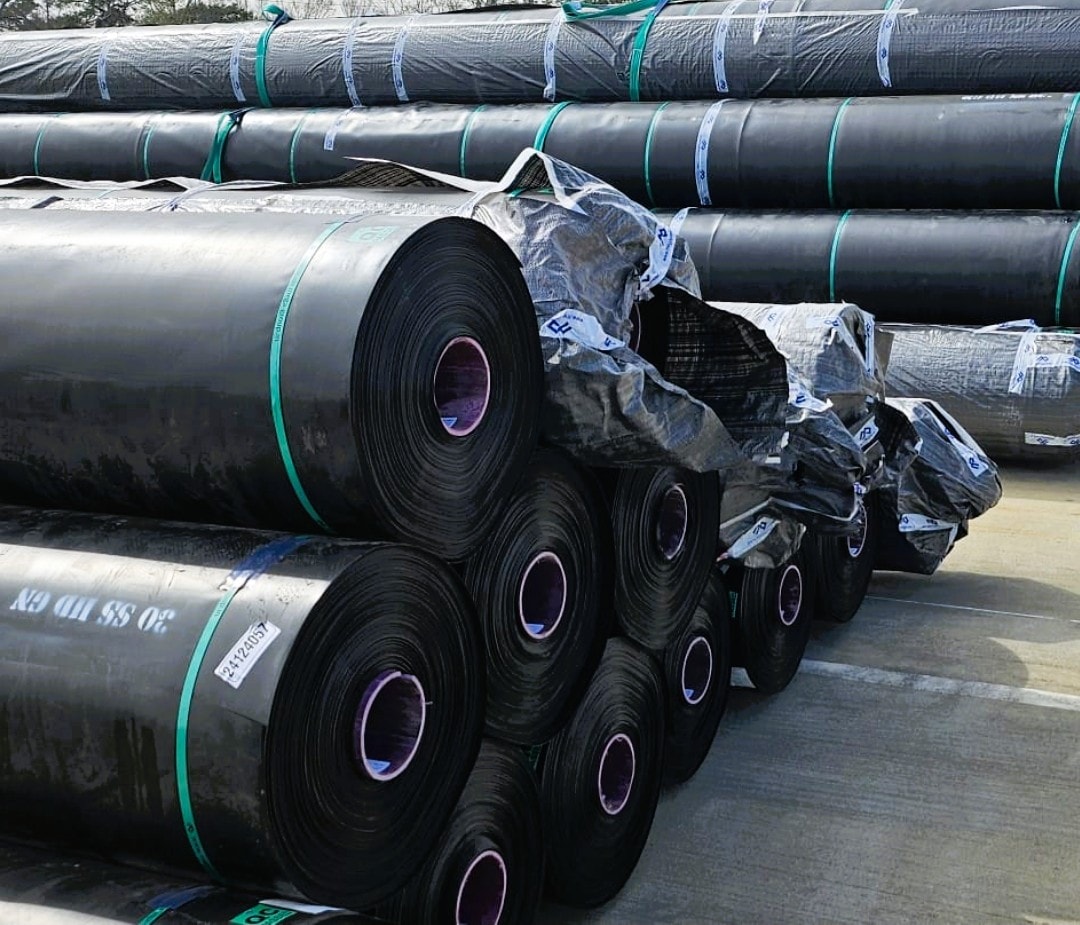 Stacked rolls of HDPE geomembrane liner ready for delivery to a job site