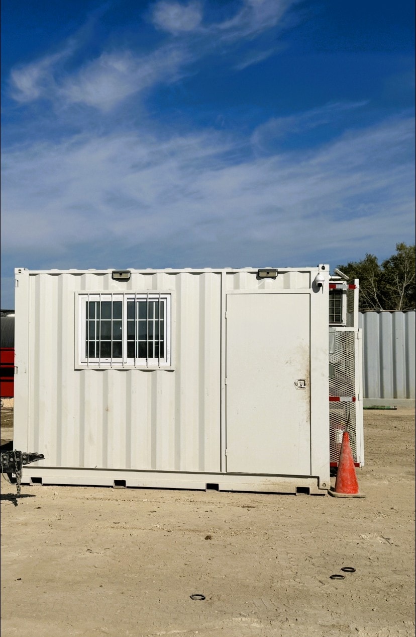 SureHold cooldown container exterior — white unit with entry door at a job site